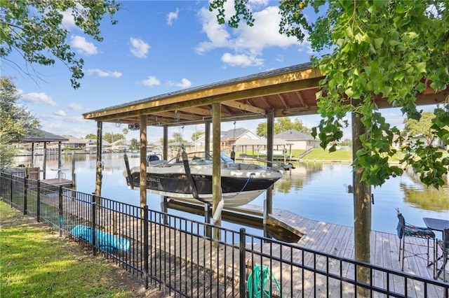 dock area with a water view and boat lift