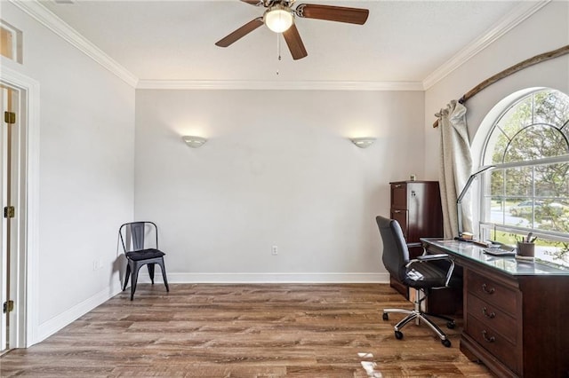 home office featuring crown molding, a ceiling fan, baseboards, and wood finished floors