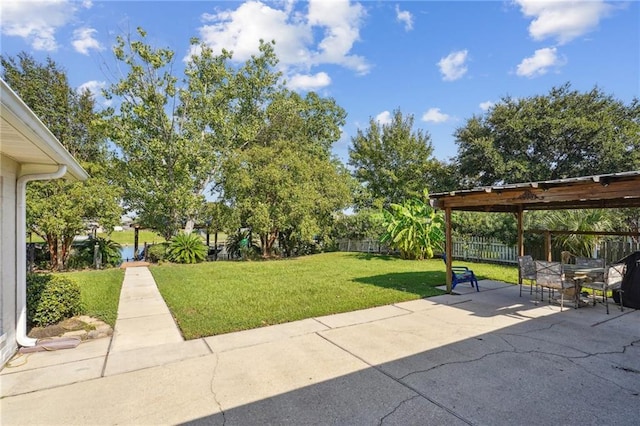 exterior space featuring a fenced backyard, outdoor dining space, a yard, and a patio area