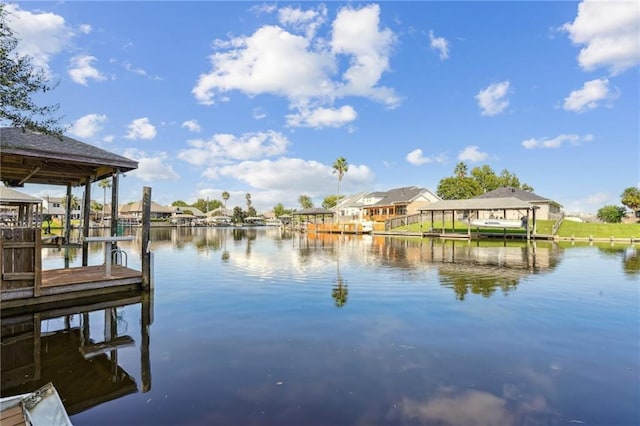 view of dock featuring a water view and a residential view