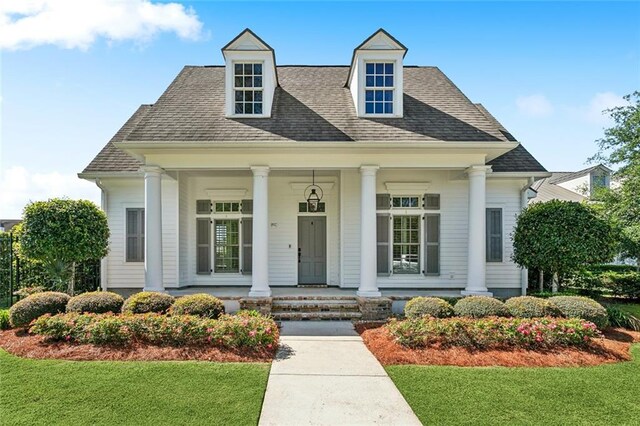 892 Chretien Point Ave, Covington, LA 70433 - view of front of house with covered porch, a front lawn, and roof with shingles