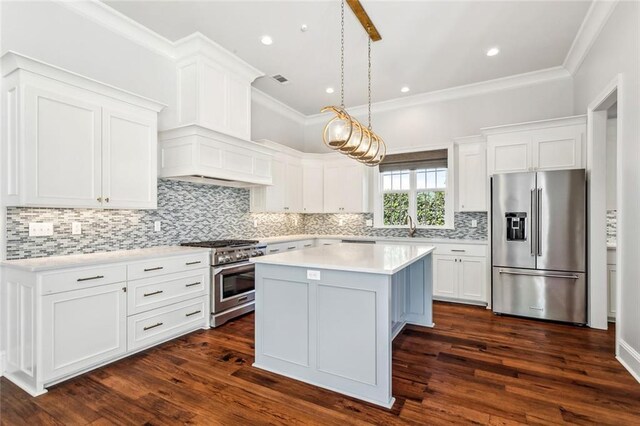 892 Chretien Point Ave, Covington, LA 70433 - kitchen with premium appliances, crown molding, light countertops, a center island, and white cabinets