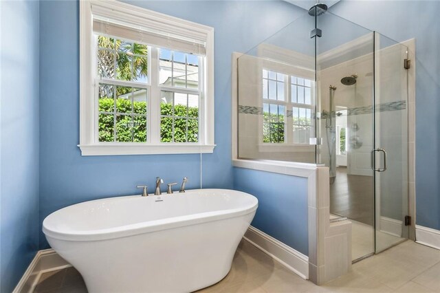 892 Chretien Point Ave, Covington, LA 70433 - full bathroom with plenty of natural light, a freestanding tub, a shower stall, and tile patterned flooring