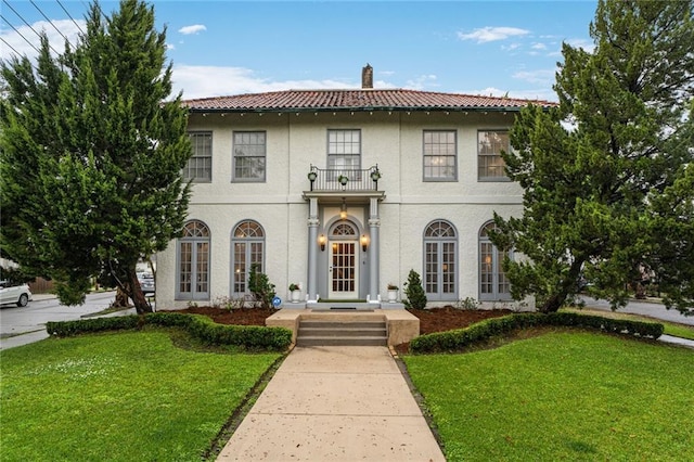 58 Fontainebleau Dr, New Orleans, LA 70125 - mediterranean / spanish home with a tiled roof, a chimney, stucco siding, and a front yard