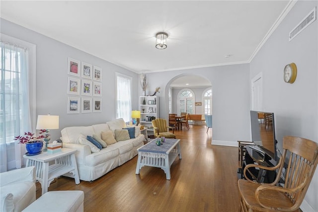 58 Fontainebleau Dr, New Orleans, LA 70125 - living area featuring visible vents, crown molding, wood finished floors, baseboards, and arched walkways