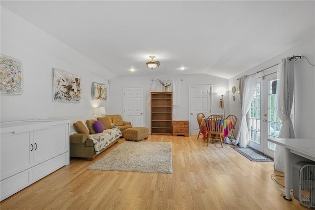 58 Fontainebleau Dr, New Orleans, LA 70125 - living room with french doors, vaulted ceiling, and light wood-type flooring