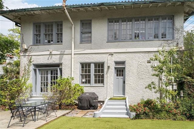 58 Fontainebleau Dr, New Orleans, LA 70125 - rear view of property featuring entry steps and stucco siding