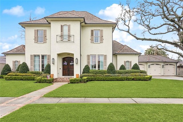 316 Sena Dr, Metairie, LA 70005 - view of front of house with concrete driveway, brick siding, an attached garage, a shingled roof, and a front yard