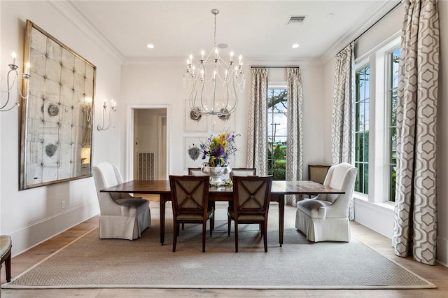 316 Sena Dr, Metairie, LA 70005 - dining room featuring wood finished floors, visible vents, a notable chandelier, and ornamental molding