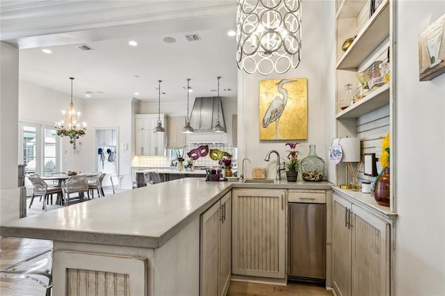 316 Sena Dr, Metairie, LA 70005 - kitchen featuring a peninsula, an inviting chandelier, decorative backsplash, custom range hood, and light countertops