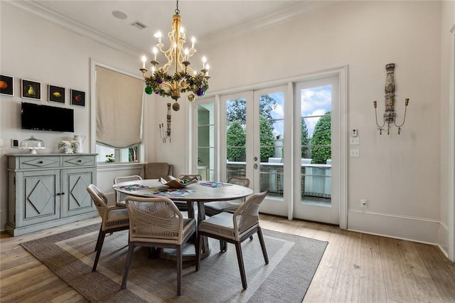 316 Sena Dr, Metairie, LA 70005 - dining space with baseboards, visible vents, a chandelier, hardwood / wood-style floors, and ornamental molding