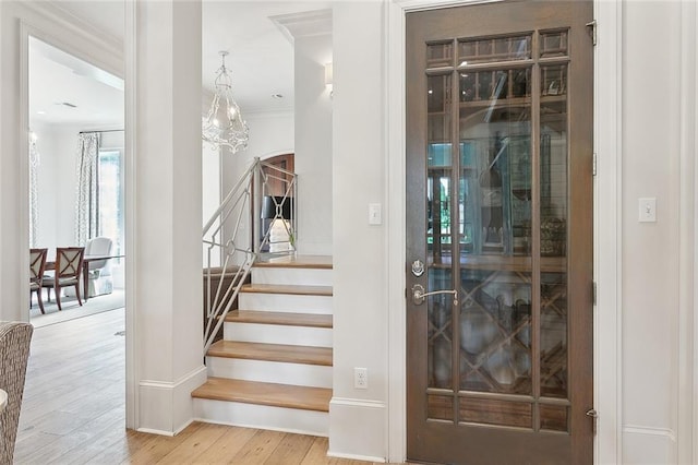 316 Sena Dr, Metairie, LA 70005 - interior space featuring arched walkways, baseboards, an inviting chandelier, wood finished floors, and crown molding