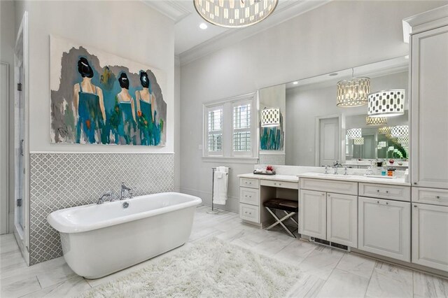316 Sena Dr, Metairie, LA 70005 - bathroom with a notable chandelier, a freestanding tub, marble finish floor, crown molding, and vanity
