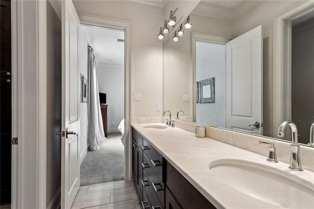 316 Sena Dr, Metairie, LA 70005 - full bath with double vanity, visible vents, crown molding, and a sink