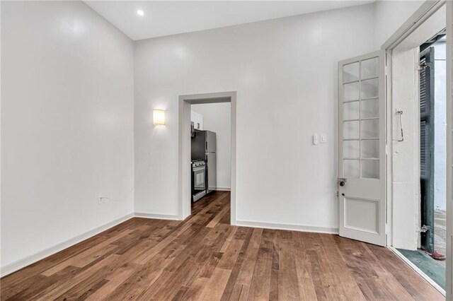 818 Bourbon St Unit 1B, New Orleans, LA 70116 - spare room with wood finished floors and baseboards