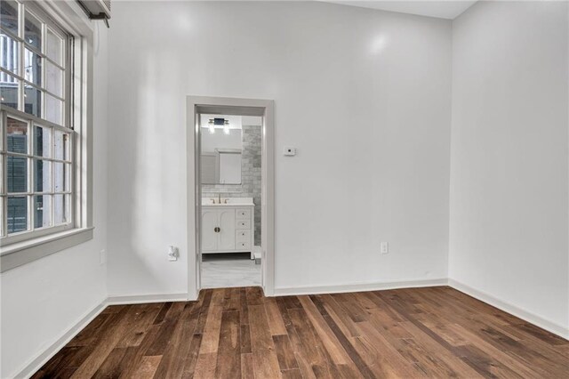 818 Bourbon St Unit 1B, New Orleans, LA 70116 - spare room with wood finished floors and baseboards