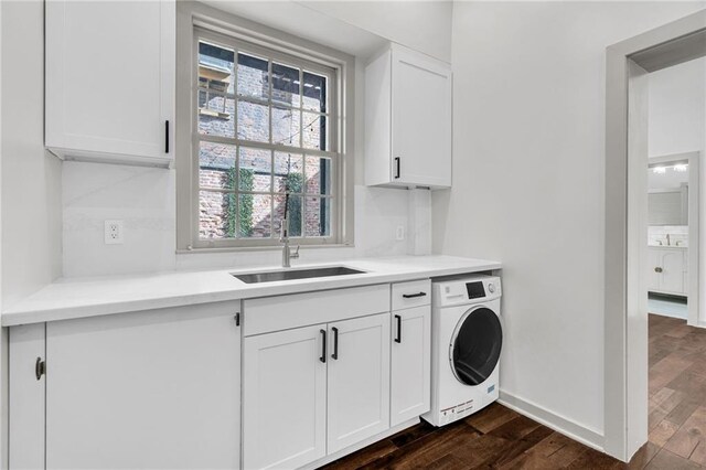 818 Bourbon St Unit 1B, New Orleans, LA 70116 - washroom featuring washer / dryer, dark wood-type flooring, baseboards, and cabinet space