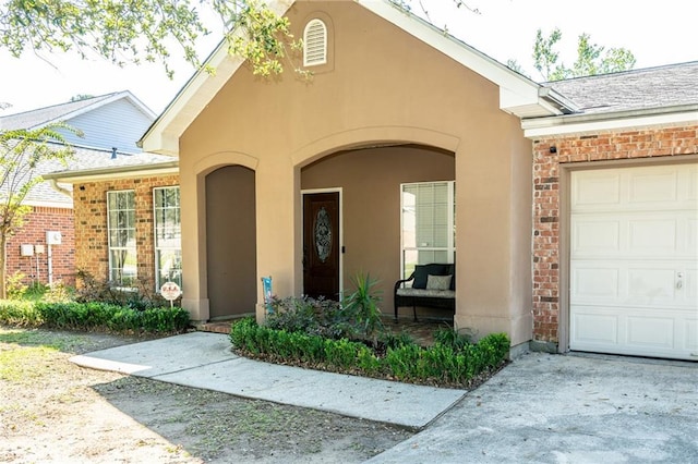1025 Breckenridge Dr, Slidell, LA 70461 - property entrance with an attached garage, stucco siding, and brick siding