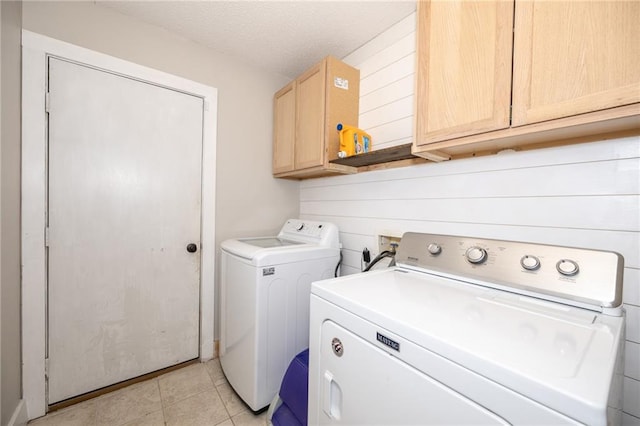 1025 Breckenridge Dr, Slidell, LA 70461 - laundry area featuring separate washer and dryer, cabinet space, and light tile patterned floors