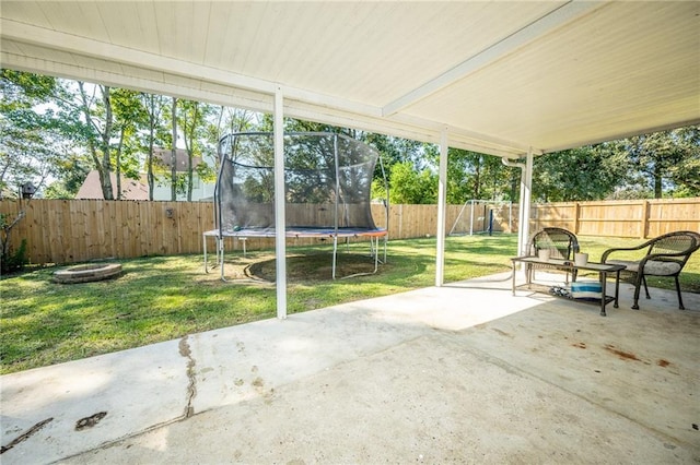 1025 Breckenridge Dr, Slidell, LA 70461 - fenced backyard featuring a trampoline and a patio area
