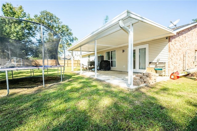 1025 Breckenridge Dr, Slidell, LA 70461 - back of property featuring a trampoline, a patio area, and brick siding