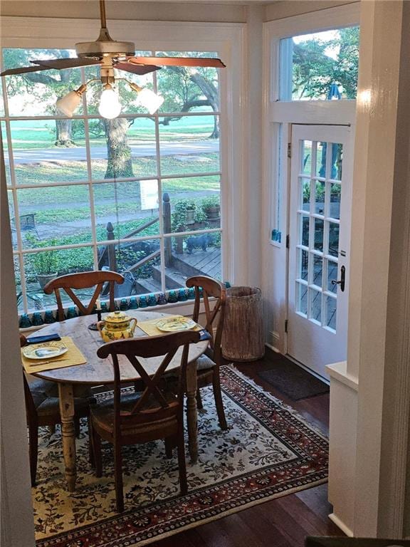 dining space featuring a ceiling fan and wood finished floors