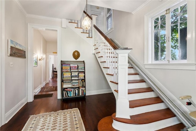 staircase with a wealth of natural light, baseboards, and wood finished floors