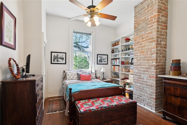 bedroom featuring wood finished floors, baseboards, and ceiling fan