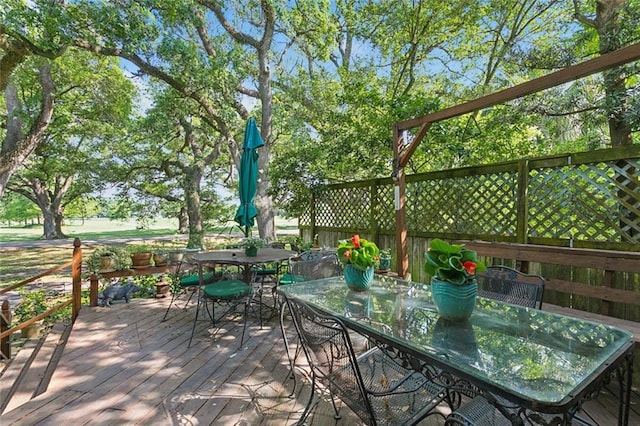 wooden terrace featuring outdoor dining area