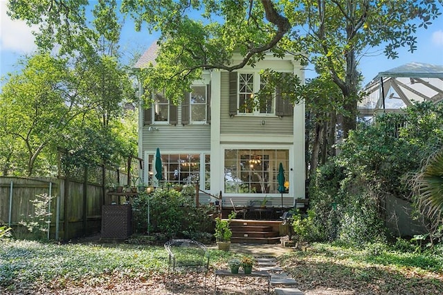 rear view of house with fence