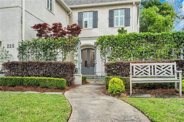 225 Ridgewood Dr, Metairie, LA 70005 - view of exterior entry featuring french doors and a shingled roof