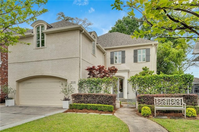 225 Ridgewood Dr, Metairie, LA 70005 - traditional home featuring concrete driveway, a front lawn, and stucco siding