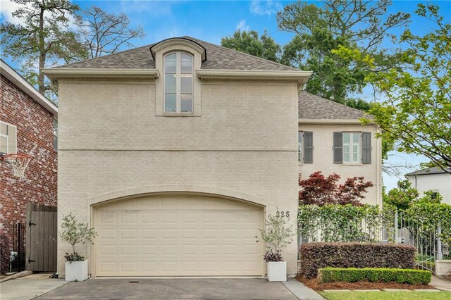 225 Ridgewood Dr, Metairie, LA 70005 - view of front of home featuring roof with shingles, aphalt driveway, and fence
