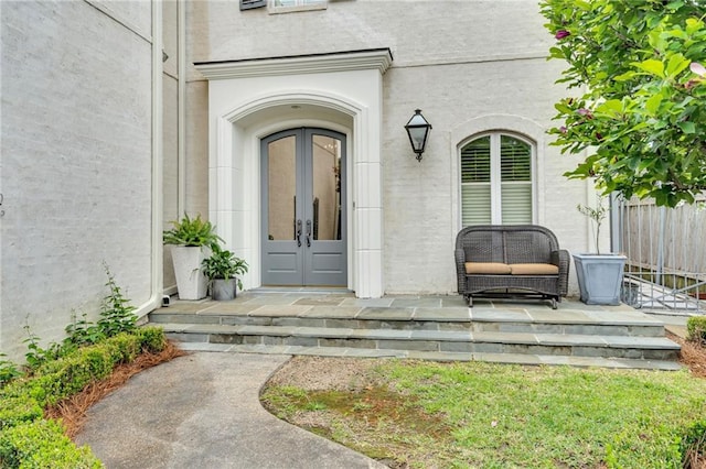 225 Ridgewood Dr, Metairie, LA 70005 - entrance to property with french doors, fence, and stucco siding