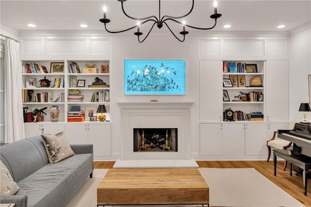 225 Ridgewood Dr, Metairie, LA 70005 - living area with built in features, a notable chandelier, wood finished floors, and a fireplace