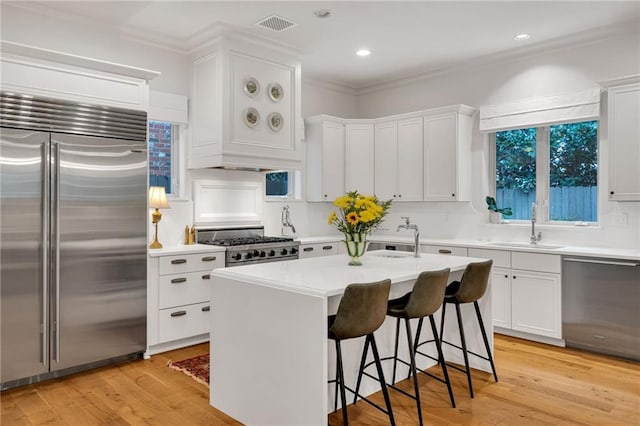 225 Ridgewood Dr, Metairie, LA 70005 - kitchen featuring light countertops, a sink, white cabinetry, and stainless steel appliances