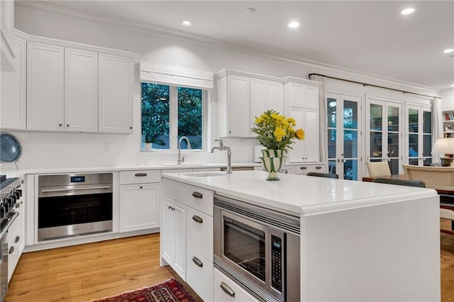 225 Ridgewood Dr, Metairie, LA 70005 - kitchen with stainless steel appliances, recessed lighting, white cabinets, and crown molding