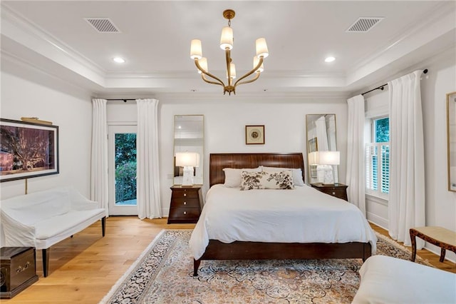 225 Ridgewood Dr, Metairie, LA 70005 - bedroom featuring light wood-style flooring, a tray ceiling, and visible vents