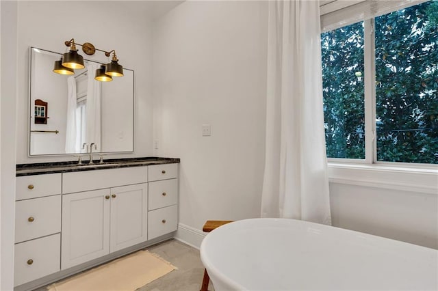 225 Ridgewood Dr, Metairie, LA 70005 - full bath with baseboards, a freestanding bath, and vanity