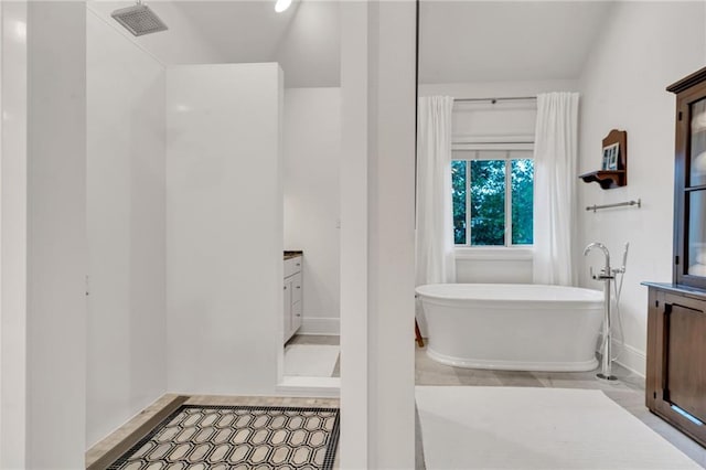 225 Ridgewood Dr, Metairie, LA 70005 - bathroom featuring visible vents, baseboards, a freestanding bath, and vanity