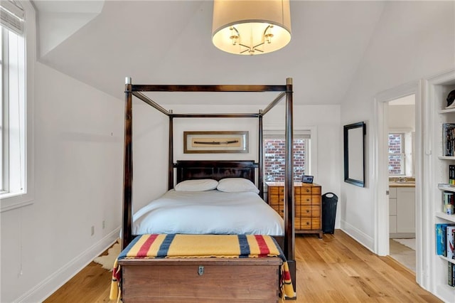 225 Ridgewood Dr, Metairie, LA 70005 - bedroom with light wood-type flooring, baseboards, and vaulted ceiling