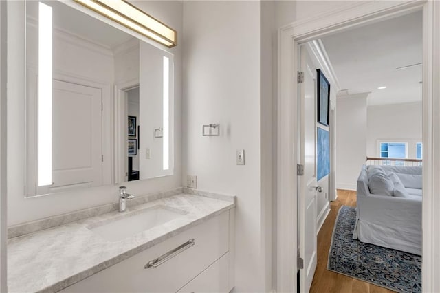225 Ridgewood Dr, Metairie, LA 70005 - bathroom featuring crown molding, wood finished floors, and vanity