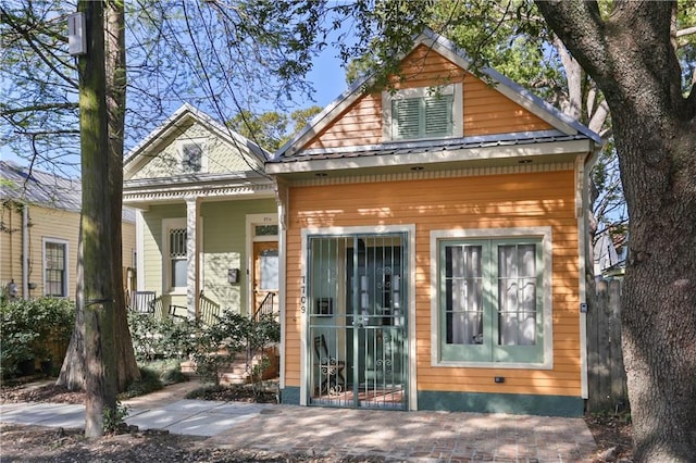 exterior space featuring metal roof and covered porch