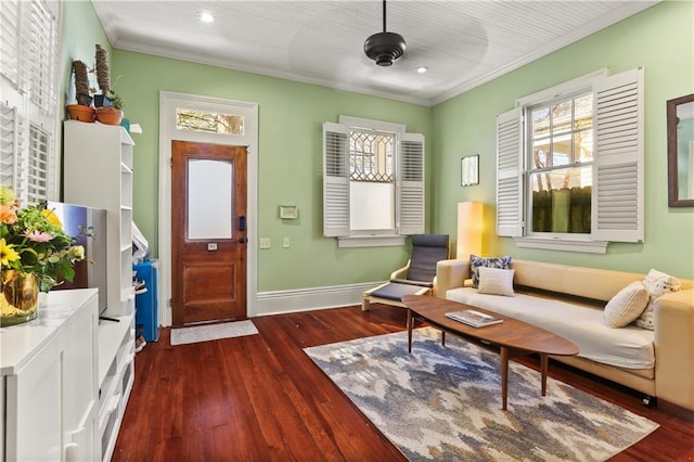 living room featuring a wealth of natural light, baseboards, and dark wood finished floors