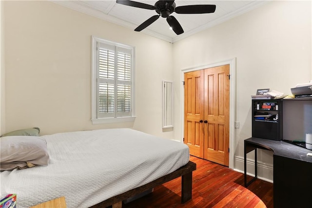 bedroom with crown molding, ceiling fan, and dark wood finished floors