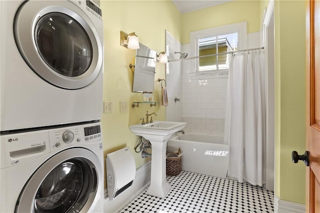 bathroom with a sink, tile patterned floors, stacked washer and clothes dryer, and shower / bathtub combination with curtain