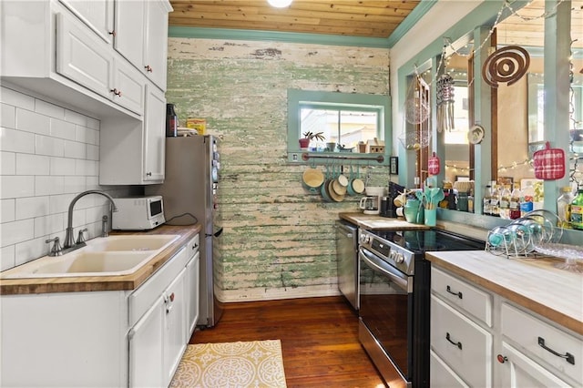 kitchen featuring white cabinets, wooden ceiling, a sink, dark wood finished floors, and stainless steel appliances