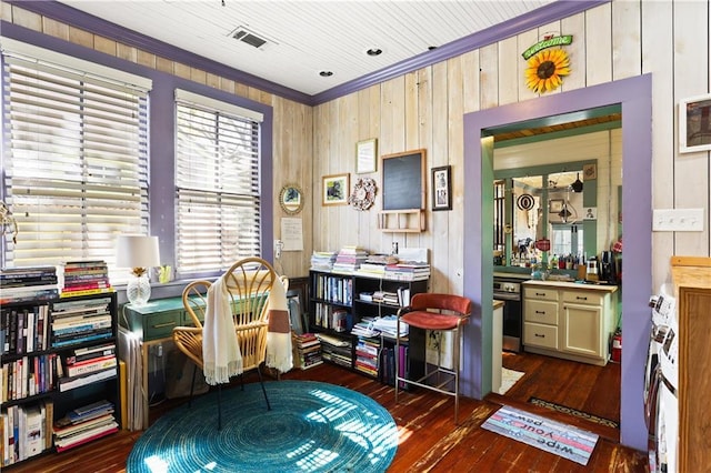 office area featuring plenty of natural light, visible vents, ornamental molding, and dark wood finished floors