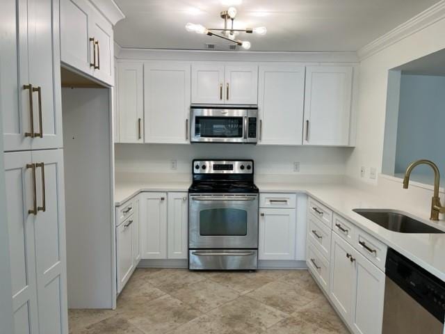 272 Marina Dr, Slidell, LA 70458 - kitchen with crown molding, light countertops, white cabinets, a sink, and appliances with stainless steel finishes