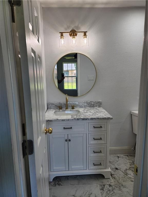 2405 Tattersall Dr, Harvey, LA 70058 - bathroom featuring toilet, marble finish floor, baseboards, and vanity